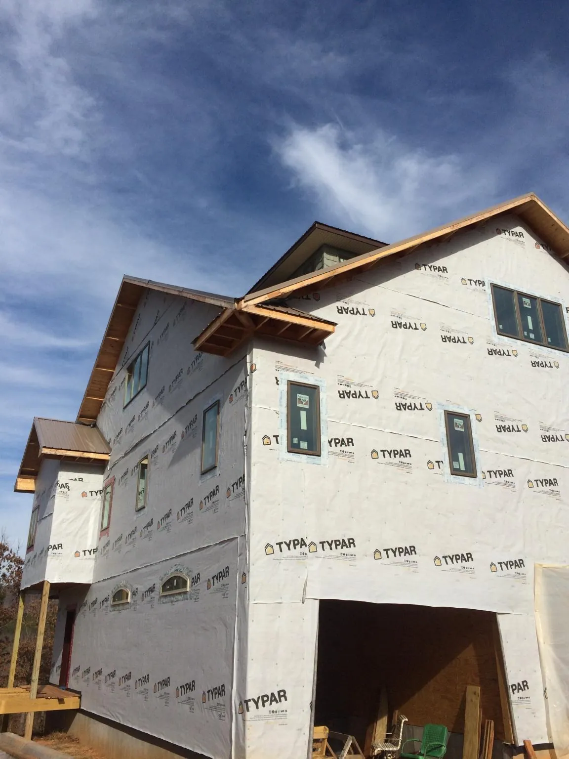 Stick built house wrapped in Typar with new roof framing and dormers in Waltham